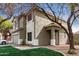 Two-story home with a two-car garage, neutral paint scheme, lawn, and mature trees at 1635 W Dunbar Dr, Phoenix, AZ 85041