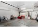 Spacious garage with concrete flooring, overhead lighting, and some furniture and personal items at 1635 W Dunbar Dr, Phoenix, AZ 85041