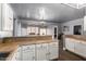 Open kitchen with light cabinets, breakfast bar, and view into a large living space at 1635 W Dunbar Dr, Phoenix, AZ 85041