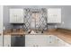 Kitchen sink and dishwasher, framed by classic cabinets and an updated countertop at 1635 W Dunbar Dr, Phoenix, AZ 85041