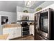 Updated kitchen features stainless steel appliances, white cabinets, and ample counter space at 1635 W Dunbar Dr, Phoenix, AZ 85041