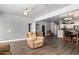 Open living room area with laminate floors, ceiling fans, and an open kitchen at 1635 W Dunbar Dr, Phoenix, AZ 85041
