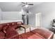 Bright living room with large, comfy sectional, modern fan, and view to other rooms at 1635 W Dunbar Dr, Phoenix, AZ 85041