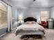 Comfortable main bedroom with two windows, stylish bedside tables, and modern ceiling fan at 1635 W Dunbar Dr, Phoenix, AZ 85041