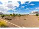 Large undeveloped lot, views of distant homes and mountains in background at 1645 E Minton St, Mesa, AZ 85203