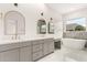 Luxurious bathroom featuring double sinks, soaking tub and white marble floors at 1645 E Minton St, Mesa, AZ 85203