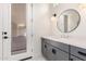 Bathroom with modern fixtures features a black framed round mirror at 1645 E Minton St, Mesa, AZ 85203