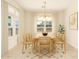Elegant dining room with a modern chandelier, neutral decor, and views through the windows at 1645 E Minton St, Mesa, AZ 85203