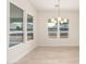 Bright dining room features wood-look flooring and an elegant light fixture, complemented by ample natural light at 1645 E Minton St, Mesa, AZ 85203