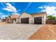 New construction home featuring desert landscaping, a paver driveway, a stone facade, and two garage bays at 1645 E Minton St, Mesa, AZ 85203
