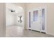 Clean, open foyer with white trim, tiled floors, and a view into the main living area with ceiling fan at 1645 E Minton St, Mesa, AZ 85203