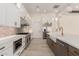Well-equipped kitchen boasts stainless steel appliances, white cabinetry, a farmhouse sink, and ample counter space at 1645 E Minton St, Mesa, AZ 85203
