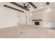 Open living area with tile floors, stone fireplace, wood beam ceiling, an iron chandelier, and lots of light at 1645 E Minton St, Mesa, AZ 85203