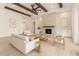 Spacious living room with a stone fireplace, wood beams, and neutral-toned furniture at 1645 E Minton St, Mesa, AZ 85203