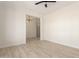 A view of an empty room with tile floors, white walls, base trim, and an iron chandelier at 1645 E Minton St, Mesa, AZ 85203