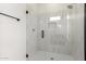 Walk in shower features vertically stacked tile and glass shower door at 1645 E Minton St, Mesa, AZ 85203