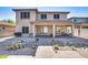 Inviting backyard with desert landscaping, brick pavers, and a covered patio for outdoor living at 16532 W Rowel Rd, Surprise, AZ 85387