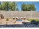 Backyard area featuring seating around a fire pit, desert landscaping, and rock accents at 16532 W Rowel Rd, Surprise, AZ 85387