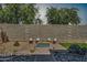 Backyard area featuring seating around a fire pit, desert landscaping, and rock accents at 16532 W Rowel Rd, Surprise, AZ 85387