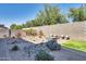 Lush backyard oasis with a fire pit, water feature, desert landscaping, and patio seating at 16532 W Rowel Rd, Surprise, AZ 85387