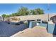 Beautiful backyard with a built-in barbecue, waterfall feature, and desert landscaping for relaxation at 16532 W Rowel Rd, Surprise, AZ 85387