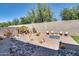 Beautiful backyard with desert landscaping, a fire pit, and a rock water feature for relaxation at 16532 W Rowel Rd, Surprise, AZ 85387