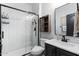 Modern bathroom boasts a glass-enclosed shower with white subway tile and a dark vanity with updated fixtures at 16532 W Rowel Rd, Surprise, AZ 85387