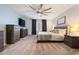 Spacious bedroom featuring a large bed, dressers, and neutral decor with a ceiling fan for added comfort at 16532 W Rowel Rd, Surprise, AZ 85387