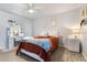 Neutral-toned bedroom with ample sunlight, wood-look tile flooring, and modern furniture at 16532 W Rowel Rd, Surprise, AZ 85387