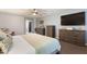 Well-lit bedroom with a plush king-size bed, dressers for ample storage, and soft, inviting decor at 16532 W Rowel Rd, Surprise, AZ 85387