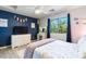 A stylish bedroom features wood-look flooring, a neutral wall, and decorative details at 16532 W Rowel Rd, Surprise, AZ 85387