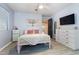 Bright bedroom featuring wood-look floors, a ceiling fan, and a decorative art piece over the comfortable bed at 16532 W Rowel Rd, Surprise, AZ 85387