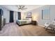 Cozy bedroom with neutral tones, a large window, and a comfortable seating area with a rocking chair at 16532 W Rowel Rd, Surprise, AZ 85387