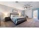 Light-filled bedroom with a king-size bed, a comfortable seating area, and a dresser for storage at 16532 W Rowel Rd, Surprise, AZ 85387