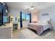 Well-lit bedroom featuring neutral walls, wood-look flooring, and a decorative window at 16532 W Rowel Rd, Surprise, AZ 85387