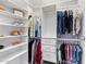 Walk-in closet with organized shelving, drawers, and hanging rods for optimal storage at 16532 W Rowel Rd, Surprise, AZ 85387