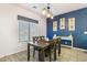 Inviting dining area with wood-look flooring, ship lap accent wall, and stylish lighting at 16532 W Rowel Rd, Surprise, AZ 85387