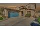 Exterior shot of the home with a well-manicured lawn, and a two-car garage at 16532 W Rowel Rd, Surprise, AZ 85387