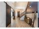 Beautiful foyer featuring wood-look tile, a staircase, a decorative bench, and a sliding barn door at 16532 W Rowel Rd, Surprise, AZ 85387