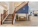 The foyer features a staircase, wood-look floors, and a cozy bench with decorative accents at 16532 W Rowel Rd, Surprise, AZ 85387