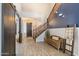 Inviting foyer with wood-look tile, a staircase, and a decorative bench at 16532 W Rowel Rd, Surprise, AZ 85387