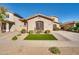 Charming house with a well-manicured front yard and lovely landscaping at 16532 W Rowel Rd, Surprise, AZ 85387