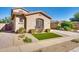 Charming home with a well-kept front yard, rocks, and beautiful landscaping at 16532 W Rowel Rd, Surprise, AZ 85387