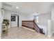 Hallway featuring wood railings and modern lighting fixture, leading to a bedroom at 16532 W Rowel Rd, Surprise, AZ 85387