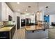 The kitchen features a large island, stainless steel appliances, and a stylish backsplash at 16532 W Rowel Rd, Surprise, AZ 85387