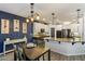 The kitchen flows to a dining area with stylish lighting, stainless appliances, and sleek cabinetry at 16532 W Rowel Rd, Surprise, AZ 85387