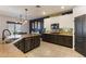 The kitchen features granite counters, stainless steel appliances, and stylish dark blue and white cabinets at 16532 W Rowel Rd, Surprise, AZ 85387