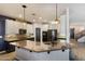 The kitchen is equipped with a granite island, stainless steel appliances, and sleek modern finishes at 16532 W Rowel Rd, Surprise, AZ 85387