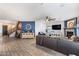 An expansive living room with an electric fireplace and tiled floors throughout at 16532 W Rowel Rd, Surprise, AZ 85387