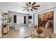 Spacious living room boasts wood-look floors, a modern ceiling fan, and plenty of natural light at 16532 W Rowel Rd, Surprise, AZ 85387